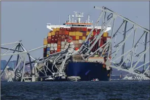  ?? (AP/Julia Nikhinson) ?? Wreckage of the Francis Scott Key Bridge rests on the container ship Dali in Baltimore on Saturday.