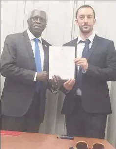  ??  ?? Director General of the GCAA Lieutenant Colonel (ret’d) Egbert Fields (left) handed over the first Helideck licence to Country Manager of TLC Guyana Inc, Mathieu Guiraud yesterday morning.