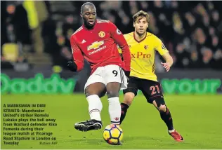  ?? Picture: AFP ?? A MARKSMAN IN DIRE STRAITS: Manchester United's striker Romelu Lukaku plays the ball away from Watford defender Kiko Femenia during their league match at Vicarage Road Stadium in London on Tuesday