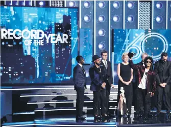 ?? MATT SAYLES, THE ASSOCIATED PRESS ?? Bruno Mars accepts the award for record of the year for 24K Magic at the 60th annual Grammy Awards in New York. Grammy viewership slipped below the 20 million mark, down 24 per cent from 2017 and the music awards show's smallest audience since 2009.