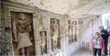  ?? — AFP ?? Guests enter a newly-discovered tomb at the Saqqara necropolis, 30 kilometres south of Cairo, belonging to the high priest ‘Wahtye’ who served during the fifth dynasty reign of King Neferirkar­e (between 2500-2300 BC).