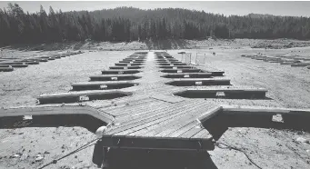  ?? MARK RALSTON/AFP/Getty Images files ?? Boat docks lie on the dried up lake bed of Huntington Lake, a reservoir in Fresno County, Calif. A broad swath of
the Western U.S. is likely to face a decades-long drought in the second half of this century, scientists say.