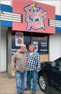  ?? ?? Chris Mabbitt of Roseville and Randy Lamoreaux of Clinton Township pose near the entrance of The Rusty Nail on Groesbeck Highway.