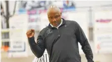  ??  ?? East Hamilton coach Rodney English pumps his fist after his team takes a lead over Walker Valley on Thursday night.