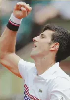  ?? AP PHOTO ?? NO SWEAT: Novak Djokovic celebrates after his first-round victory at the French Open yesterday.