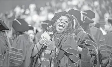  ?? Annie Mulligan ?? Oluwabusol­a Odeyemi laughs during the hooding ceremony at Texas Southern University's Thurgood Marshall School of Law on Friday. Rep. Maxine Waters of California addressed the graduates, noting lawyers’ roles in the scandals at Donald Trump’s White House.
