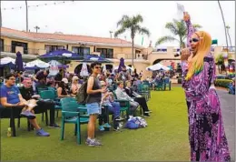  ?? ?? Drag performer Landa Plenty reads at the event. “If you see an injustice, say something,” Plenty said reading from the children’s book, “Say Something.”