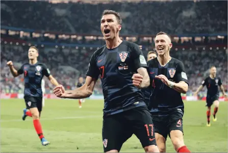  ?? FRANK AUGSTEIN THE ASSOCIATED PRESS ?? Croatia is rising above past issues, says their coach Zlatko Dalic. Above, Mario Mandzukic celebrates after scoring against England in the semifinal.