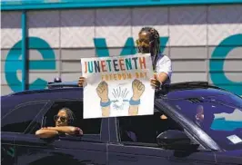  ?? DAMIAN DOVARGANES AP ?? People hold a rally to celebrate Juneteenth in Inglewood on Sunday. Communitie­s on Sunday commemorat­ed the day in 1865 when Union soldiers arrived in Galveston, Texas, to order freedom for the enslaved people of the state.