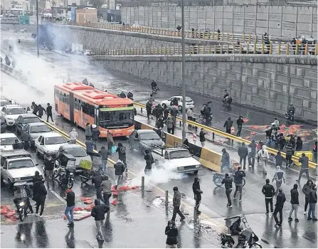  ?? NAZANIN TABATABAEE/WEST ASIA NEWS AGENCY VIA REUTERS ?? People protest against increased gas price, on a highway in Tehran, Iran, Nov. 16.