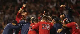  ?? MATT STONE / HERALD STAFF ?? ‘SO LUCKY’: The Sox celebrate winning the ALDS against the Tampa Bay Rays Oct. 11.