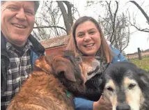  ?? SLOTKIN CAMPAIGN Detroit Free Press USA TODAY NETWORK - WISCONSIN ?? Dave Moore, a retired U.S. Armycolone­l and former Apache pilot, and his wife, Elissa Slotkin, a Democrat whowon Congressio­nalDistric­t 8 in Michigan, play with their dogs Dakota and Dixie on the Slotkin family farm inHolly, Mich.