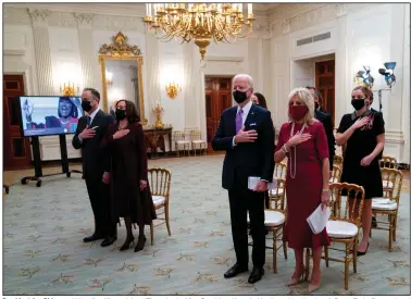  ?? (The New York Times/Doug Mills) ?? President Joe Biden and his wife, Jill, are joined Thursday by Vice President Kamala Harris and her husband, Doug Emhoff, at a virtual Presidenti­al Inaugural Prayer Service in the State Dining Room of the White House. Behind the Bidens are other family members.