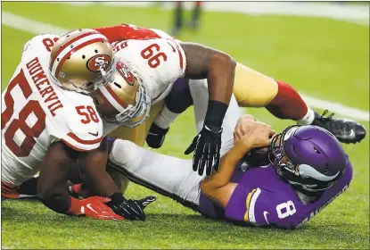  ?? JIM MONE — ASSOCIATED PRESS ?? 49ers defenders Elvis Dumervil and DeForest Buckner take down Minnesota QB Sam Bradford during the first half on Sunday.