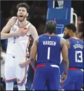  ?? ?? Thunder forward Chet Holmgren (7) celebrates near Clippers guard James Harden (1) and forward Paul George (13) after Holmgren bounced the ball to himself off the backboard and then dunked during the second half, Thursday, in Oklahoma City.
