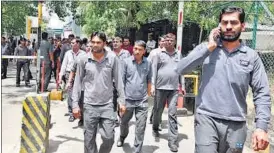  ??  ?? Airport employees come out of the premises after rumours of a radioactiv­e leak spread on Friday morning. An emergency response team rushed to the spot to contain the alleged leak. RAJ K RAJ/ HT PHOTO