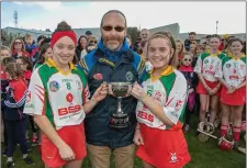  ??  ?? Joint captains Leah Furlong and Miriam O’Keeffe accepting the McCarthy Cup from Con O Ceadaigh.