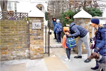  ??  ?? Children are dropped off by their parents at Southbank Internatio­nal School in London as schools reopen following the easing of the coronaviru­s lockdown. — AFP photo