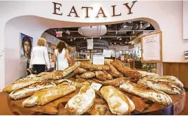  ??  ?? Freshly baked breads are displayed at the entrance to Eataly in downtown’s new Westfield shopping center.