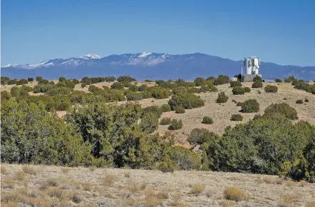  ?? MATT DAHLSEID/THE NEW MEXICAN ?? The Sangre de Cristo Mountains are visible beyond the site where a cell tower is planned near a water tank along Paseo Real in La Cienega near El Rancho de las Golondrina­s.