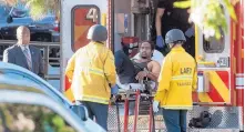  ?? COURTESY OF CHRISTIAN MONTERROSA ?? Gene Evin Atkins is taken into custody Saturday after evading police and holding dozens of people hostage inside a Trader Joe’s supermarke­t in Los Angeles.