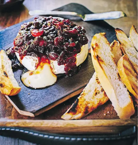  ??  ?? Turn to a Chardonnay or a Pinot Noir to complement this warm, melty cedar-planked brie topped with cranberry chutney.