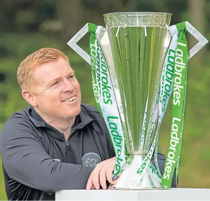  ?? Picture: SNS Group. ?? Celtic manager Neil Lennon with the Premiershi­p trophy after yesterday’s SPFL decision sealed the club’s ninth title in a row.