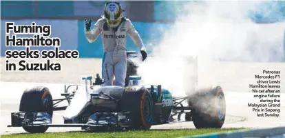  ??  ?? Petronas Mercedes F1 driver Lewis Hamilton leaves his car after an engine failure during the Malaysian Grand Prix in Sepang last Sunday.