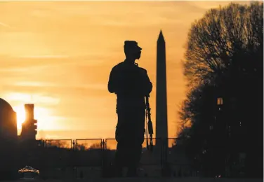  ?? Sarah Silbiger / Getty Images ?? A National Guard soldier stands near the U.S. Capitol. The Guard will remain for two more months.