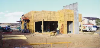  ??  ?? Workers are making progress on a new Blake’s Lotaburger location at Coors Boulevard and St Joseph Drive NW. Retailers are looking to take advantage of Albuquerqu­e’s Westside, which has seen more attention due to the relative lack of retail options.