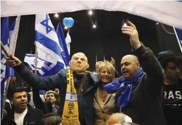 ?? (Olivier Fitoussi/Flash90) ?? LIKUD SUPPORTERS celebrate after exit polls were released on election night last March.