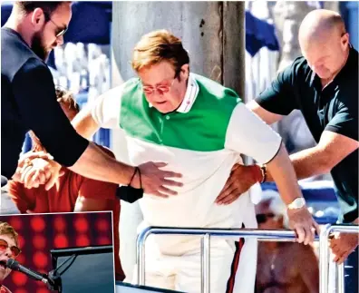  ?? ?? Give the man a big hand: Sir Elton is helped aboard a holiday yacht and, left, in full flow on stage