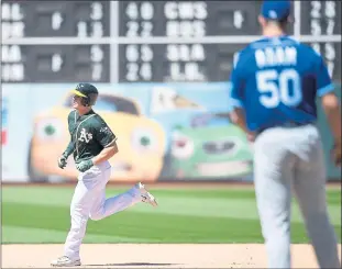  ?? THEARON W. HENDERSON — GETTY IMAGES ?? Matt Chapman trots around the bases after hitting a solo home run in the eighth inning that gave the A’s a 3-2 lead on Sunday at the Coliseum. The A’s moved two games over .500 with the win over the Royals.