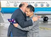  ?? U.S. STATE DEPARTMENT ?? U.S. Ambassador to Switzerlan­d Edward T. McMullen Jr., left, welcomes Xiyue Wang on Saturday in Switzerlan­d.