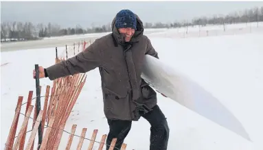  ?? RENÉ JOHNSTON/TORONTO STAR ?? T.J. Atwood is a local surfer. Atwood and his crew braved the waters of the Toronto Islands during the storm.