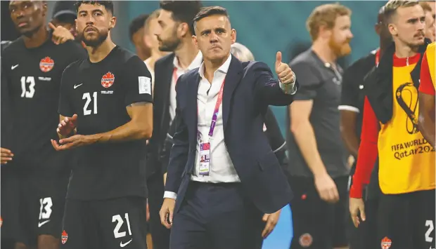  ?? REUTERS ?? Canadian coach John Herdman looks dejected after Canada was eliminated from advancing to the knockout rounds of the World Cup on Sunday by a 4-1 loss to Croatia at Khalifa Internatio­nal Stadium in Al Rayyan, Qatar. Canada has one final match to play on Thursday against Morocco.