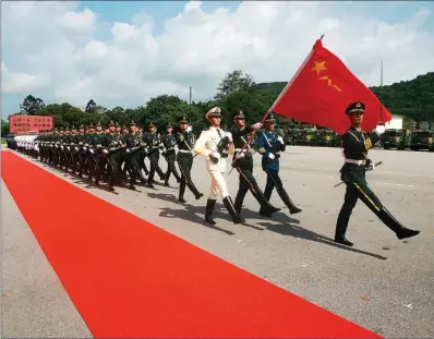  ?? PROVIDED TO CHINA DAILY ?? The Guard of Honor of the People’s Liberation Army Hong Kong Garrison march at a flag-raising ceremony during an open day last year.