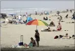  ?? MARCIO JOSE SANCHEZ — THE ASSOCIATED PRESS ?? People crowd the beach Thursday in Huntington Beach. Gov. Gavin Newsom has ordered beaches in Orange County to close until further notice amid the COVID-19 pandemic.