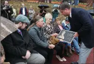  ?? The Sentinel-Record/RICHARD RASMUSSEN ?? Oaklawn Park President Louis Cella(right) presents a plaque to family members of former jockey and Oaklawn steward Larry Snyder including his son Larry Snyder Jr. (second from left) during a ceremony naming the new winner’s circle after Snyder on Thursday. Snyder died Monday after a bout with cancer.