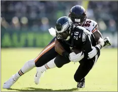  ?? MATT ROURKE — THE ASSOCIATED PRESS ?? The Eagles’ Jordan Howard, left, rushes for a TD against the Bears Sunday as Miles Sanders, right, is brought down by the Bears’ James Vaughn. Both backs are flourishin­g as the Birds recommit to the run.