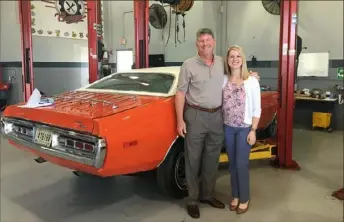  ?? Courtesy of Randy Dye ?? Randy Dye and his daughter, Nikki Risley, with the 1972 Dodge Charger during restoratio­n. The car was awarded to Roberto Clemente for being the MVP of the 1971 World Series.