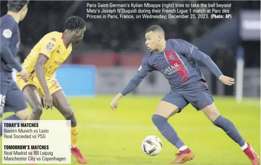  ?? (Photo: AP) ?? Paris Saint-germain’s Kylian Mbappe (right) tries to take the ball beyond Metz’s Joseph N’duquidi during their French Ligue 1 match at Parc des Princes in Paris, France, on Wednesday, December 20, 2023.