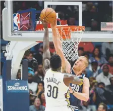  ?? Veronica Dominach, The Associated Press ?? Nuggets forward Mason Plumlee blocks the ball against New Orleans forward Julius Randle on Saturday night. Randle had 21 points and 10 rebounds.