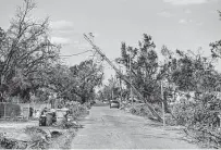  ?? Emily Kask / New York Times ?? Downed power lines are seen Sept. 11 in Luling, La., where some customers did not get power restored until Friday.