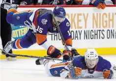  ?? KATHY WILLENS THE ASSOCIATED PRESS FILE PHOTO ?? New York Islanders right-winger Cal Clutterbuc­k goes flying after tripping over Edmonton Oilers defenceman Brandon Davidson in a February 2016 National Hockey League contest. Clutterbuc­k, a Welland native, is hoping to win the Stanley Cup for the first time in his 17-year NHL career.