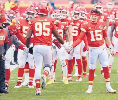  ?? JAMIE SQUIRE/GETTY ?? Chiefs’ Patrick Mahomes (15) greets Chris Jones (95) before the AFC playoff game against the Browns on Jan. 17.