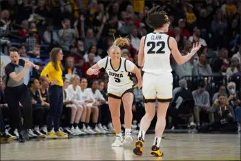  ?? ABBIE PARR — THE ASSOCIATED PRESS ?? Iowa guard Sydney Affolter (3) celebrates toward guard Caitlin Clark (22) after making a 3-point basket during the first half of an NCAA college basketball game against Michigan in the semifinals of the Big Ten women’s tournament Saturday, March 9, 2024, in Minneapoli­s.