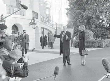  ?? ALEX BRANDON/AP ?? President Donald Trump, seen with first lady Melania Trump, talks with the media Jan. 20 before boarding Marine One on the South Lawn of the White House. It was Trump’s final day as commander in chief before heading to Florida.