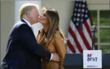  ?? SUSAN WALSH — THE ASSOCIATED PRESS ?? President Donald Trump kisses first lady Melania Trump following an event where Melania Trump announced her initiative­s in the Rose Garden of the White House in Washington, Monday.