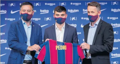  ??  ?? Bartomeu y Ramon Planes flanquean a Pedri en el acto de presentaci­ón del joven futbolista tinerfeño en el Auditori 1899.